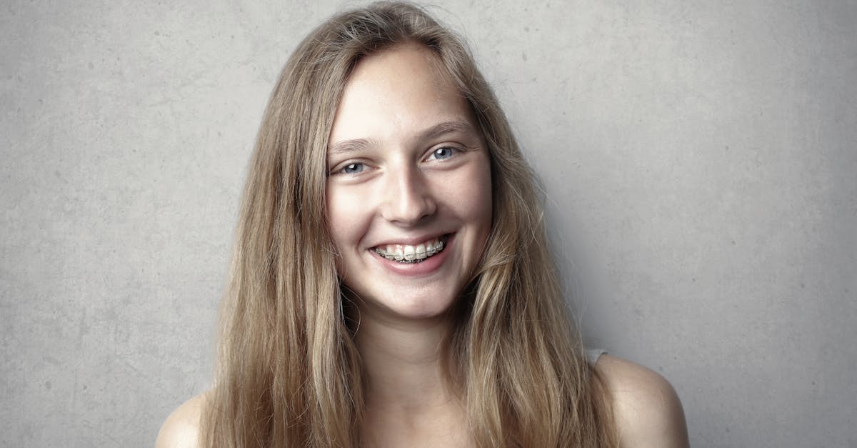 portrait of a happy young woman with braces smiling at the camera